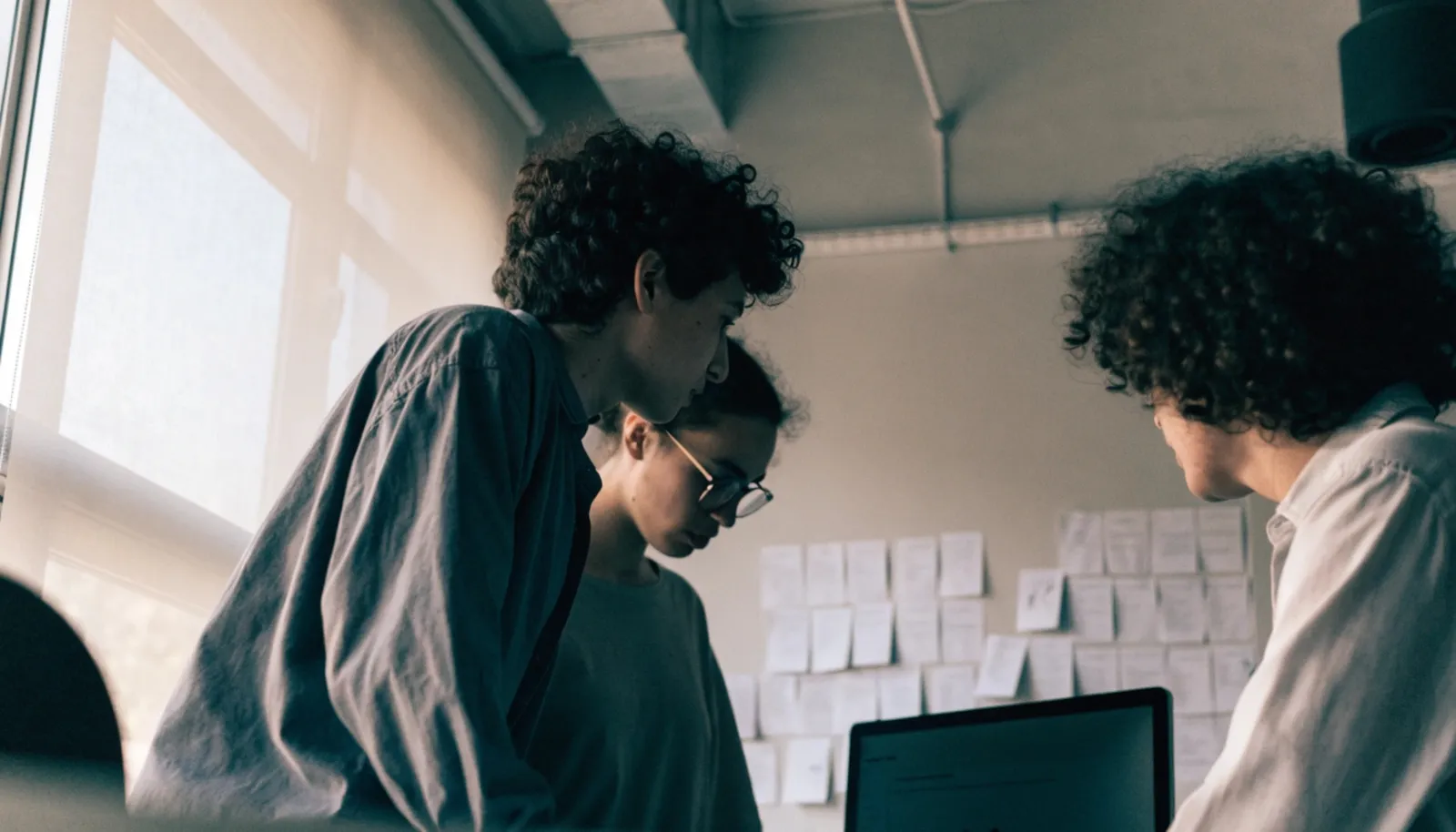 A small agency team reviewing more incoming project work than its own staff can build, the situation that leads agencies to a white label partner