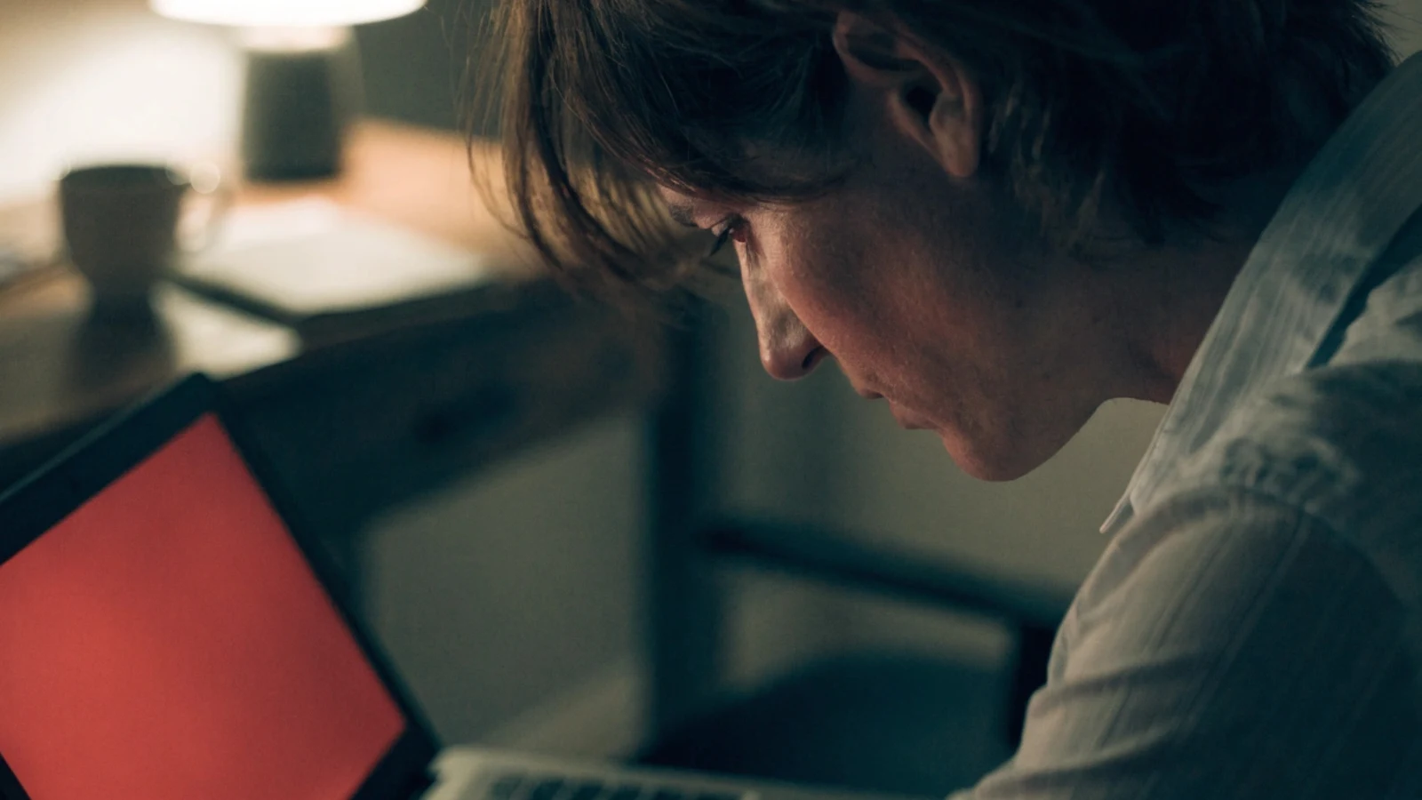 Small business owner reacting to a security warning on their laptop screen after discovering their WordPress site has been hacked